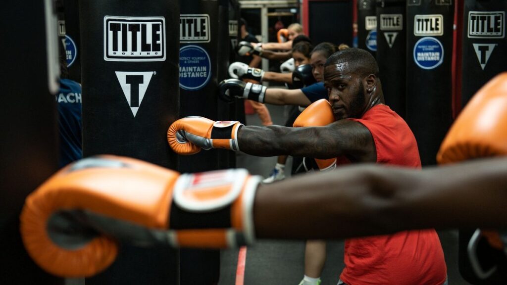 Gants orange au contact pendant un échange en salle de boxe